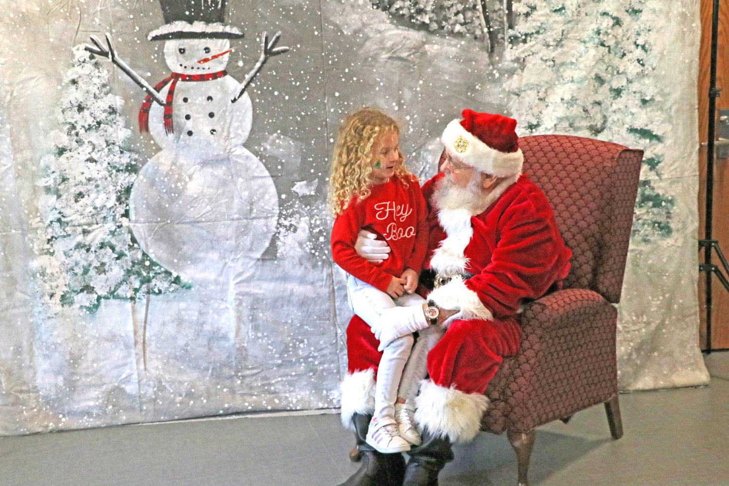 Livia Ball, 6, sits on Santa’s lap during Christmas in Kalona